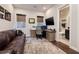 Home office offering a comfortable couch and office setup with natural light and adjacent bathroom at 29 Costa Tropical Dr, Henderson, NV 89011
