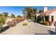 Private backyard featuring desert landscaping, shrubbery, and mature trees overlooking green space at 2905 Legend Dr, Las Vegas, NV 89134