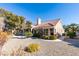 Single-story home with desert landscaping featuring native plants, rock cover, and mature trees at 2905 Legend Dr, Las Vegas, NV 89134
