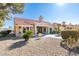 Single story home with a red tile roof and desert landscaping with small plants and shrubbery at 2905 Legend Dr, Las Vegas, NV 89134