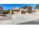Single-story home with desert landscaping, a two-car garage, and a concrete driveway and sidewalk at 2905 Legend Dr, Las Vegas, NV 89134