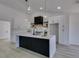 Bright kitchen features marble countertops, shaker cabinets, stainless steel appliances, and a center island at 2905 Legend Dr, Las Vegas, NV 89134