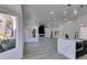 Bright living room with sleek gray floors, modern lighting, and a contemporary kitchen island at 2905 Legend Dr, Las Vegas, NV 89134