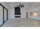 Open-concept living room features a fireplace, sliding glass doors to the patio, and modern design at 2905 Legend Dr, Las Vegas, NV 89134
