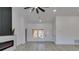 Bright living room features a ceiling fan, light gray flooring, and a modern electric fireplace at 2905 Legend Dr, Las Vegas, NV 89134