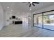 Open-concept living room boasts an open-concept kitchen, large sliding glass doors, and high ceilings at 2905 Legend Dr, Las Vegas, NV 89134
