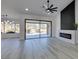 Open-concept living room features a fireplace, sliding glass doors to patio, and modern design at 2905 Legend Dr, Las Vegas, NV 89134