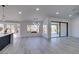 Bright living room with modern lighting, a kitchen island, and views of the exterior at 2905 Legend Dr, Las Vegas, NV 89134