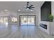 Bright living room features a fireplace, sliding glass doors to patio, and modern design elements at 2905 Legend Dr, Las Vegas, NV 89134