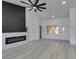 Bright living room with a modern fireplace, and doorway with transom windows to entryway at 2905 Legend Dr, Las Vegas, NV 89134