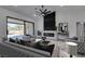 Staged living room featuring a fireplace, sliding glass doors, and modern furniture at 2905 Legend Dr, Las Vegas, NV 89134