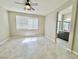 Bedroom with large windows, ceiling fan, and bathroom access at 3532 Mountain Park St, Las Vegas, NV 89129