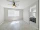 Bedroom with a ceiling fan, large window, and ensuite bathroom at 3532 Mountain Park St, Las Vegas, NV 89129
