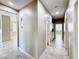 Well-lit hallway with tile flooring, leading to various rooms and featuring a neutral color scheme at 3532 Mountain Park St, Las Vegas, NV 89129
