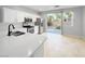 Modern kitchen featuring stainless steel appliances, white cabinets, sleek countertops, and backyard views at 3532 Mountain Park St, Las Vegas, NV 89129