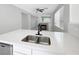 Open-concept kitchen with white cabinets, stone countertops and a view of the fireplace at 3532 Mountain Park St, Las Vegas, NV 89129