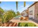 Inviting backyard oasis with a sparkling pool, comfortable lounge chairs, and lush landscaping at 38 Pebble Dunes Ct, Las Vegas, NV 89141