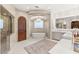 The bathroom features a soaking tub, arched doorway, walk-in shower and dual sinks at 38 Pebble Dunes Ct, Las Vegas, NV 89141