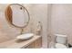 Stylish powder room featuring a unique sink, modern faucet, and decorative mirror at 38 Pebble Dunes Ct, Las Vegas, NV 89141