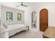 This bedroom offers ensuite access, neutral carpeting, and bright windows at 38 Pebble Dunes Ct, Las Vegas, NV 89141