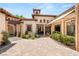 Picturesque courtyard showcasing decorative pavers, a covered portico, and exterior lighting at 38 Pebble Dunes Ct, Las Vegas, NV 89141