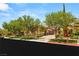 Beautiful single-story home showcasing mature trees, stone accents, and a brick driveway at 38 Pebble Dunes Ct, Las Vegas, NV 89141