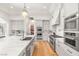 Gourmet kitchen featuring a large island, stainless steel appliances, double ovens, and custom cabinetry at 38 Pebble Dunes Ct, Las Vegas, NV 89141