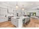 Spacious kitchen boasts modern appliances, a large island with bar seating, and seamless access to the living area at 38 Pebble Dunes Ct, Las Vegas, NV 89141