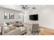 A cozy living room featuring a stylish gray sofa, patterned pillows, and an elegant overhead fan at 38 Pebble Dunes Ct, Las Vegas, NV 89141