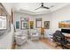 The office features hardwood floors, bright windows, and ample seating at 38 Pebble Dunes Ct, Las Vegas, NV 89141