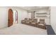 Beautiful home theater featuring four plush seats, built-in shelves, and a striking wood door at 38 Pebble Dunes Ct, Las Vegas, NV 89141