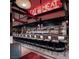 Stylish bar with neon sign and ample seating and a long countertop at 4381 W Flamingo Rd # 2902, Las Vegas, NV 89103