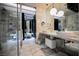 Modern bathroom featuring double sinks, marble countertops, and a glass-enclosed shower for a spa-like experience at 4381 W Flamingo Rd # 2902, Las Vegas, NV 89103