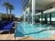 Large pool with multiple lounge chairs is surrounded by high-rise buildings and several palm trees at 4381 W Flamingo Rd # 2902, Las Vegas, NV 89103