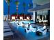 This outdoor pool features submerged seating areas, luxury cabanas, and palm trees at 4381 W Flamingo Rd # 2902, Las Vegas, NV 89103