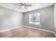 Bright bedroom featuring wood flooring, neutral walls, and a window providing natural light at 5000 Red Rock St # 120, Las Vegas, NV 89118