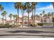 Community clubhouse at Laguna Del Rey 5000, framed by majestic palm trees and lush landscaping at 5000 Red Rock St # 120, Las Vegas, NV 89118