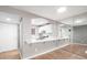 Bright kitchen with white cabinets and countertops offering an open view to the living area and front door at 5000 Red Rock St # 120, Las Vegas, NV 89118