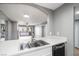 Modern kitchen featuring an open layout with stainless steel sink, and views to the living area and balcony at 5000 Red Rock St # 120, Las Vegas, NV 89118