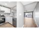 Bright kitchen featuring white cabinets, stainless steel appliances, and an open layout to the living area at 5000 Red Rock St # 120, Las Vegas, NV 89118