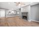 Cozy living room featuring a fireplace, wood flooring, and seamless flow to the kitchen at 5000 Red Rock St # 120, Las Vegas, NV 89118