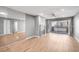 Open living room with wood flooring, a fireplace, and a large mirrored wall at 5000 Red Rock St # 120, Las Vegas, NV 89118