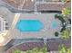 Overhead view of a community pool with palm trees, lounge chairs and a jacuzzi at 5000 Red Rock St # 120, Las Vegas, NV 89118