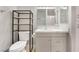 Nicely remodeled bathroom featuring gray cabinet and granite countertop at 5101 Renault Ave, Las Vegas, NV 89142