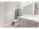 Bathroom with updated vanity, shelving, and granite countertops at 5101 Renault Ave, Las Vegas, NV 89142