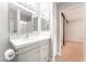 Updated bathroom featuring large mirror and modern vanity with granite countertops at 5101 Renault Ave, Las Vegas, NV 89142