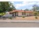 Cozy one-story home with a tile roof, minimal landscaping, and mature trees at 5101 Renault Ave, Las Vegas, NV 89142