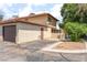 Two-story home featuring an attached garage, side door, and low-maintenance landscaping at 5101 Renault Ave, Las Vegas, NV 89142