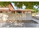 Street-level view of the home with a tile roof and privacy wall at 5101 Renault Ave, Las Vegas, NV 89142