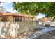 Street view showcasing the home's tile roof and block wall in a neighborhood setting at 5101 Renault Ave, Las Vegas, NV 89142